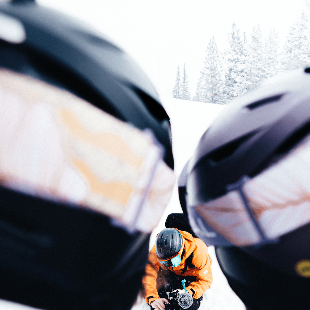 The scene is set outdoors amid a snowy landscape, likely in a mountainous area.