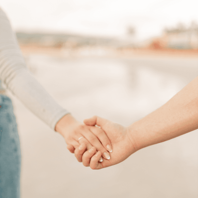 The scene takes place outdoors, along what appears to be a beach or coastal setting.