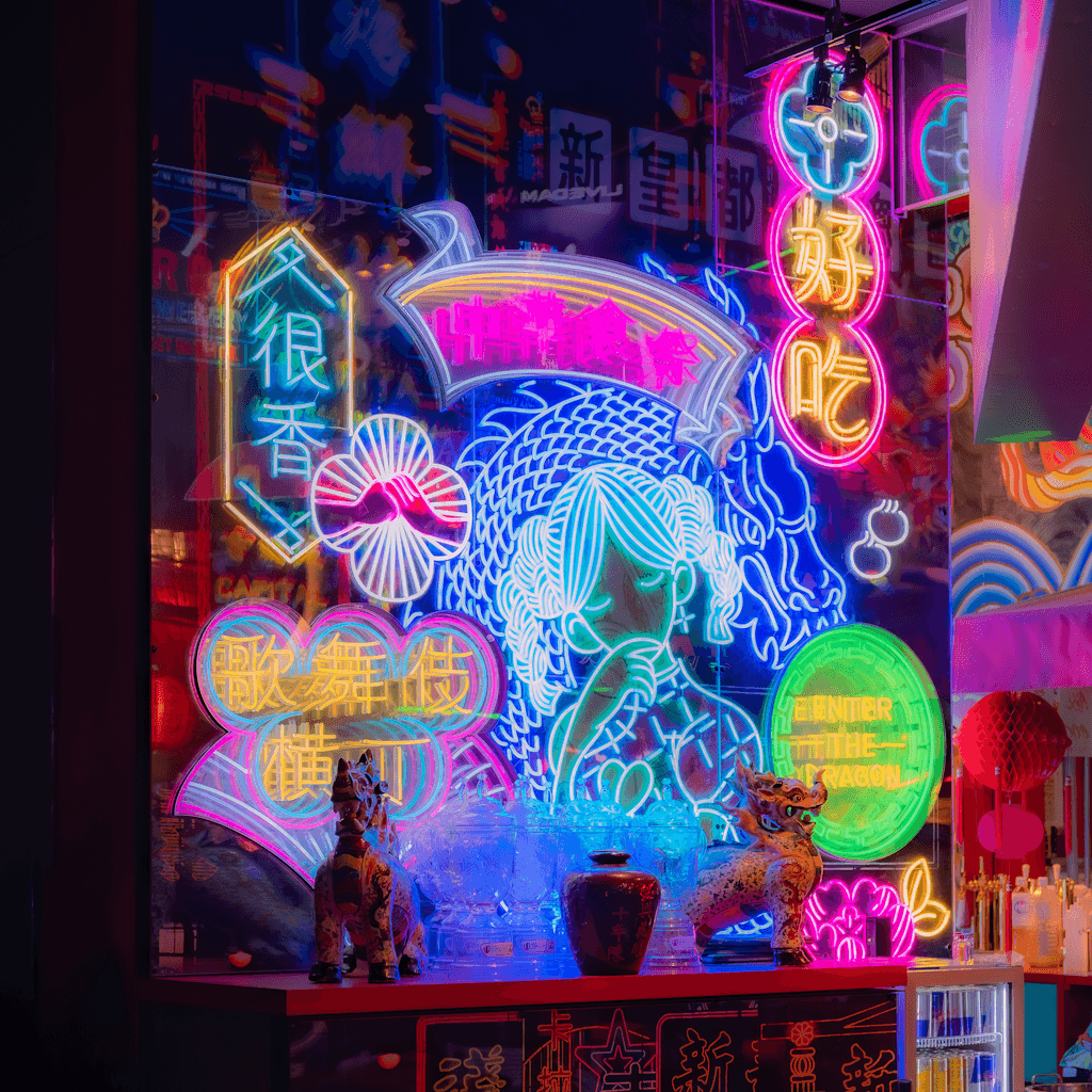 The scene unfolds indoors, most likely within a vibrant, urban setting characterized by a dazzling array of neon lights.