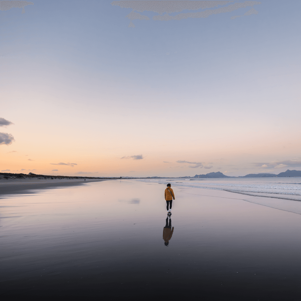 The scene is set outdoors on a vast, serene beach during the gentle transition of dusk.