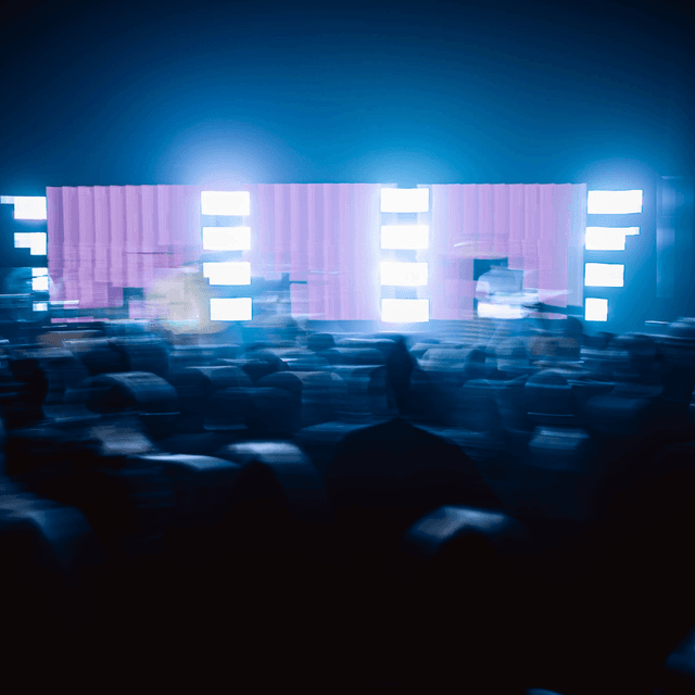 The scene is set indoors, within what appears to be a concert or performance venue.