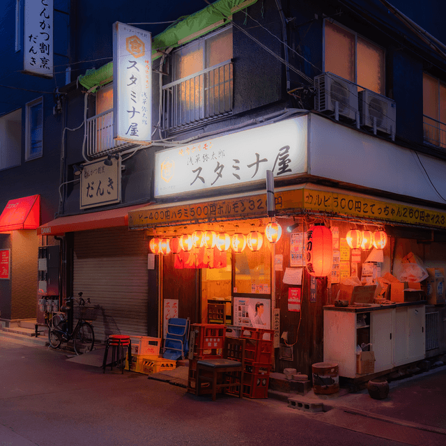 The scene is set on a quiet street corner during the gentle fade of dusk, transitioning into night.